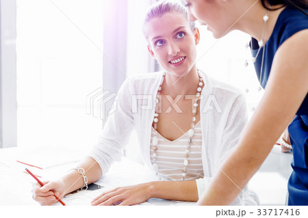 Two female colleagues in office 33717416