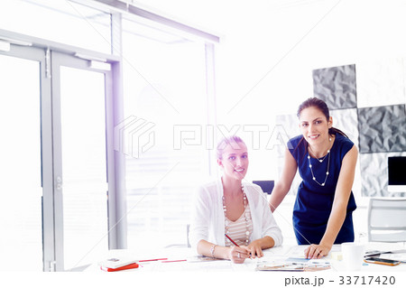 Two female colleagues in office 33717420