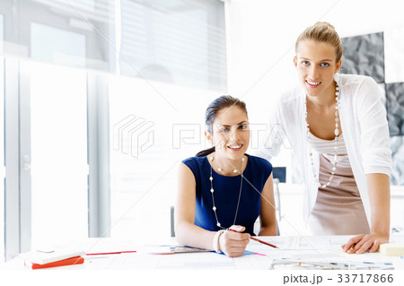 Two female colleagues in office Two female colleagues in office 33717866