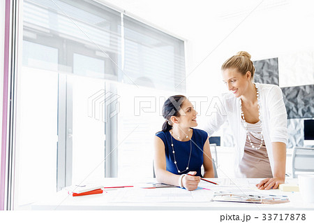 Two female colleagues in office 33717878