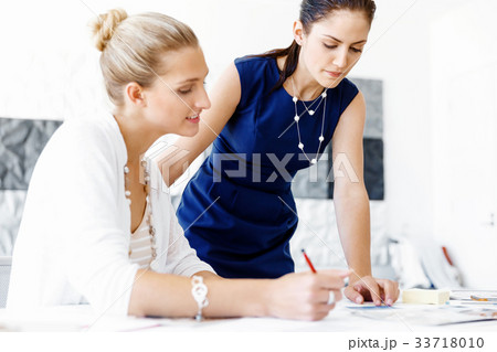 Two female colleagues in office 33718010
