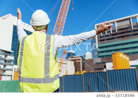 Engineer builder at construction site 33718566