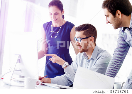 Attractive office worker sitting at desk Attractive office worker sitting at desk 33718761