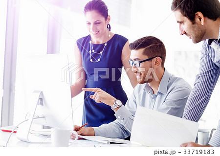 Attractive office worker sitting at desk 33719183