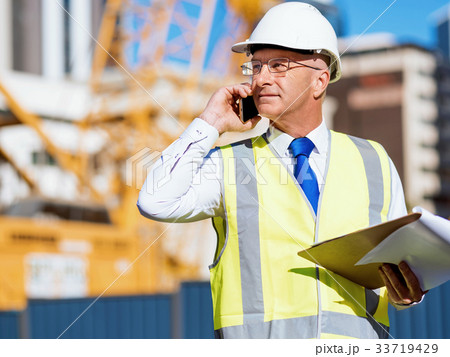 Engineer builder at construction site 33719429