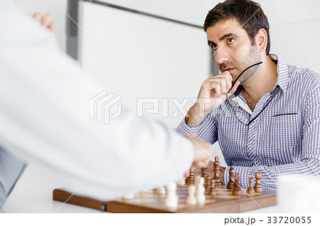 Portrait of two young man playing chess Portrait of two young man playing chess 33720055
