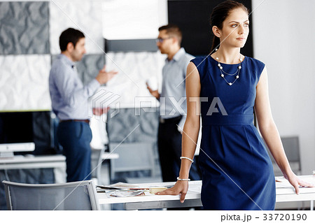 Attractive office worker standing Attractive office worker standing 33720190