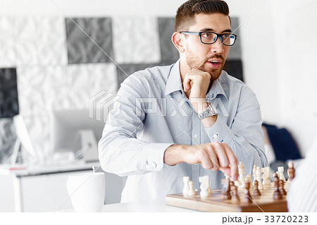 Portrait of two young man playing chess Portrait of two young man playing chess 33720223