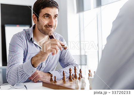 Portrait of two young man playing chess 33720233