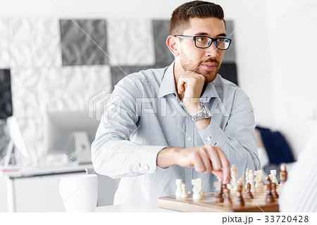 Portrait of two young man playing chess 33720428