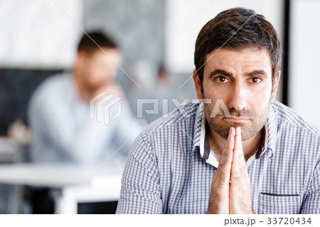 Male office worker sitting at desk 33720434