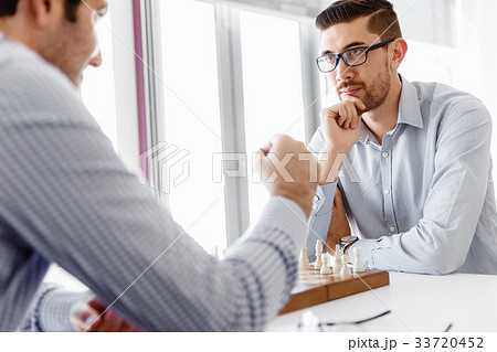 Portrait of two young man playing chess Portrait of two young man playing chess 33720452