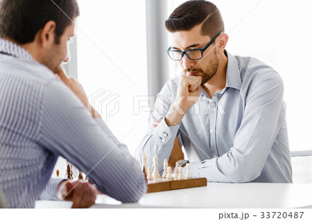 Portrait of two young man playing chess 33720487