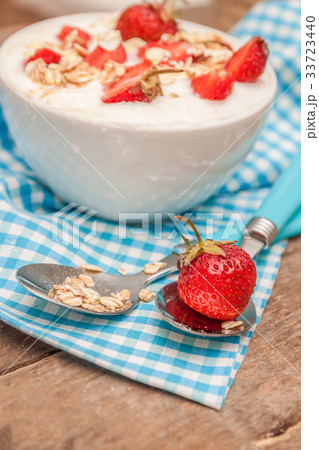 In a cup of yogurt, oat granola and fresh strawber In a cup of yogurt, oat granola and fresh strawber 33723440