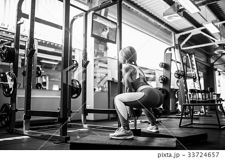 Young blonde sexy girl doing squat. 33724657