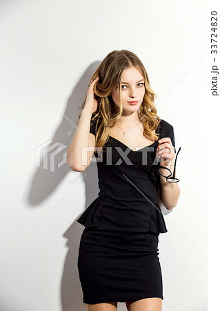 beautiful woman posing in elegant dress on the 33724820