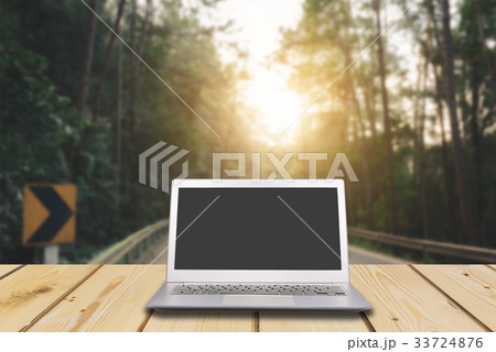 Laptop with blank screen on wooden table Laptop with blank screen on wooden table 33724876