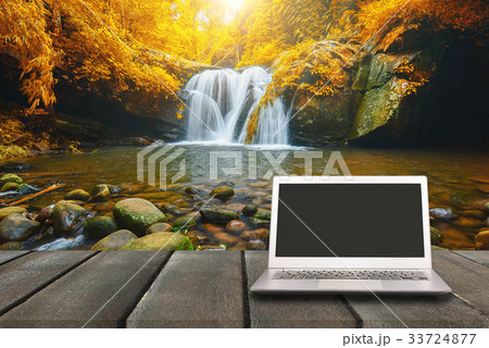 Laptop with blank screen on wooden table  Laptop with blank screen on wooden table  33724877