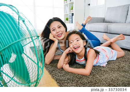 happy mother and daughter making same posing 33730034
