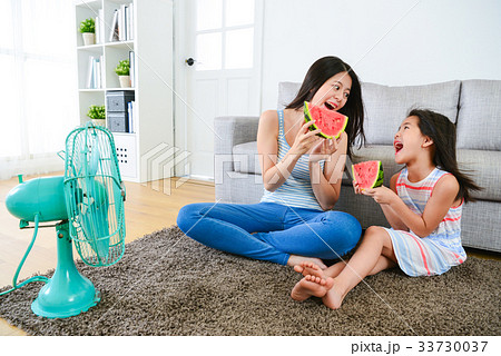 happy woman and female children holding watermelon 33730037