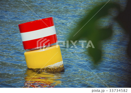 Yellow red and white navigational floating buoy Yellow red and white navigational floating buoy 33734582