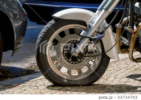 Security number padlock blocking motorcycle wheel 33734703