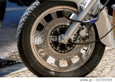 Security number padlock blocking motorcycle wheel 33734704