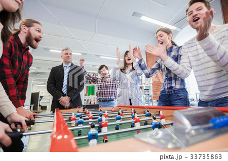 People playing table soccer People playing table soccer 33735863