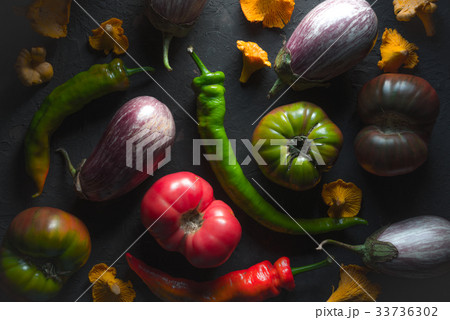 Tomatoes, aubergines, chili and chanterelles on a Tomatoes, aubergines, chili and chanterelles on a 33736302