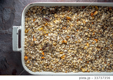 Granola mix in baking dish close-up Granola mix in baking dish close-up 33737356