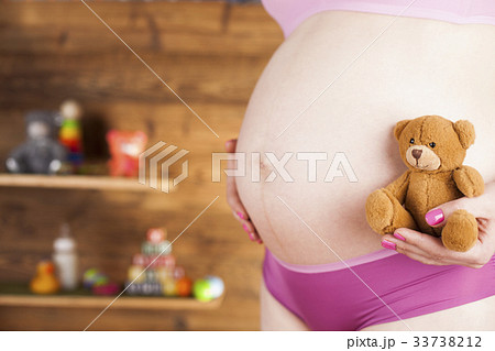 Teddy bear and Happy pregnant woman Teddy bear and Happy pregnant woman 33738212