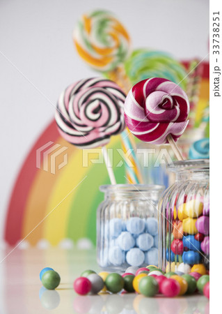 Colorful lollipops and different colored round candy and gum bal 33738251