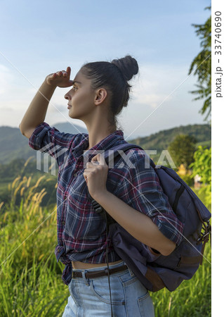 Hipster young girl with backpack enjoying sunset Hipster young girl with backpack enjoying sunset 33740690