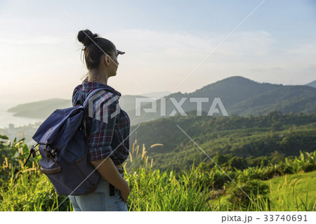 Hipster young girl with backpack enjoying sunset Hipster young girl with backpack enjoying sunset 33740691