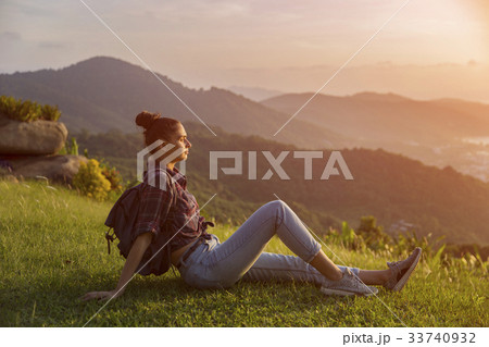 Hipster young girl with backpack enjoying sunset  33740932
