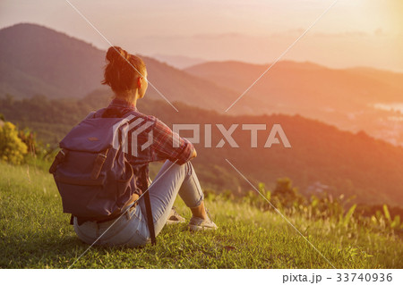 Hipster young girl with backpack enjoying sunset Hipster young girl with backpack enjoying sunset 33740936