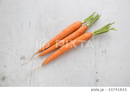 Carrot. Fresh carrot on white concrete board. Carrot. Fresh carrot on white concrete board. 33741633