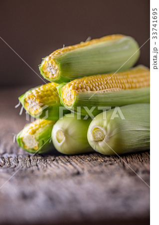Corn. Fresh corn on old rustic oak table. Corn. Fresh corn on old rustic oak table. 33741695