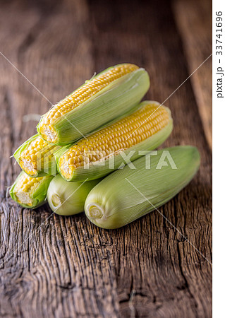 Corn. Fresh corn on old rustic oak table. 33741696