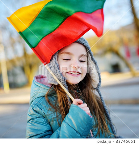Cute little girl holding Lithuanian flags in Vilnius 33745651