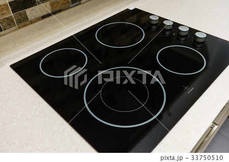 Modern black induction stove in kitchen interior 33750510