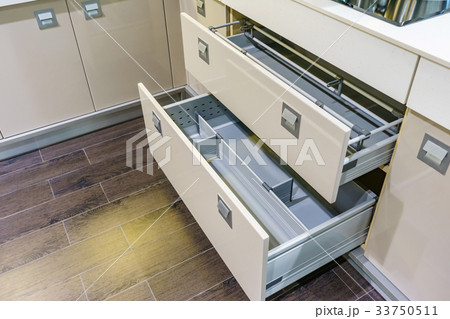 Opened kitchen drawer with plates for kitchen 33750511