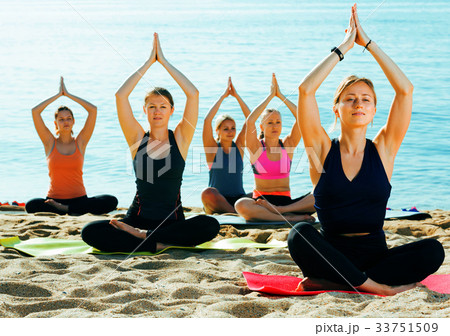 Glad girls making yoga meditation in lotus pose Glad girls making yoga meditation in lotus pose 33751509