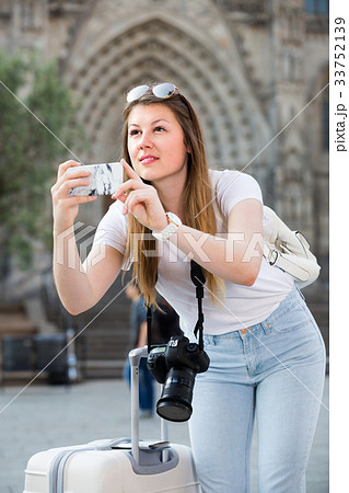 Young girl is taking photo on her phone Young girl is taking photo on her phone 33752139