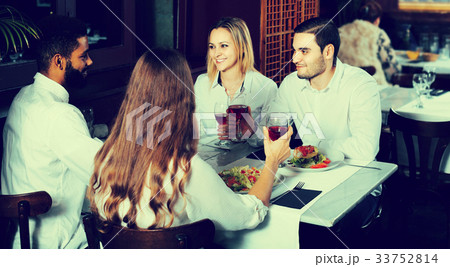middle class people enjoying food in cafe and talking 33752814