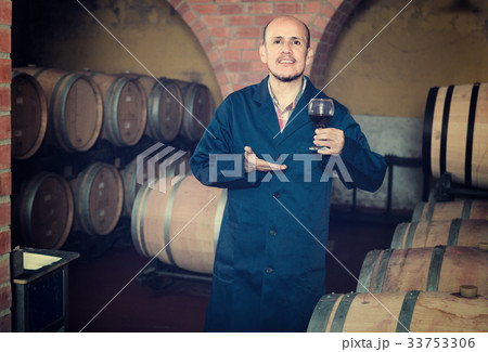 winery employee holding wine 33753306