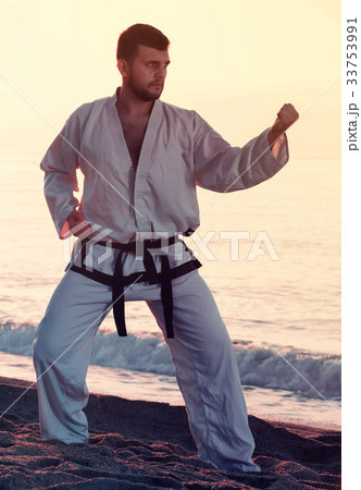 Guy practising karate at seaside 33753991