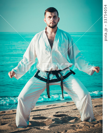 Guy practising karate at seaside Guy practising karate at seaside 33754054