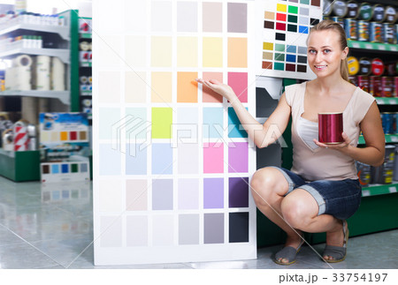 Cheerful adult woman picking color for paint 33754197