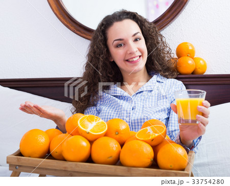 Young woman with orange juice and fruits 33754280